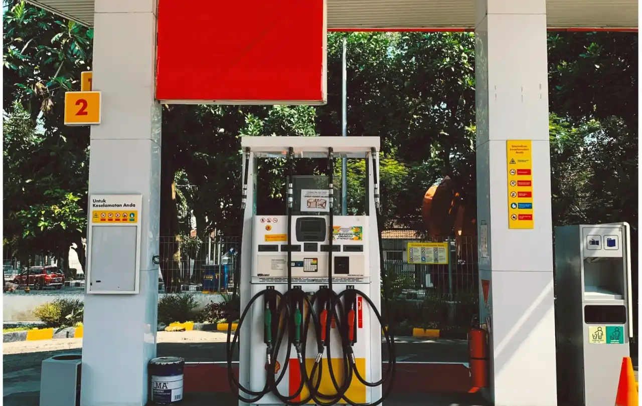 Gas station fuel dispenser connected to EMV payment, monitoring, and low-voltage communication systems in a petroleum forecourt environment
