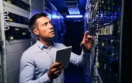 AV integrator reviewing installed components on a server rack