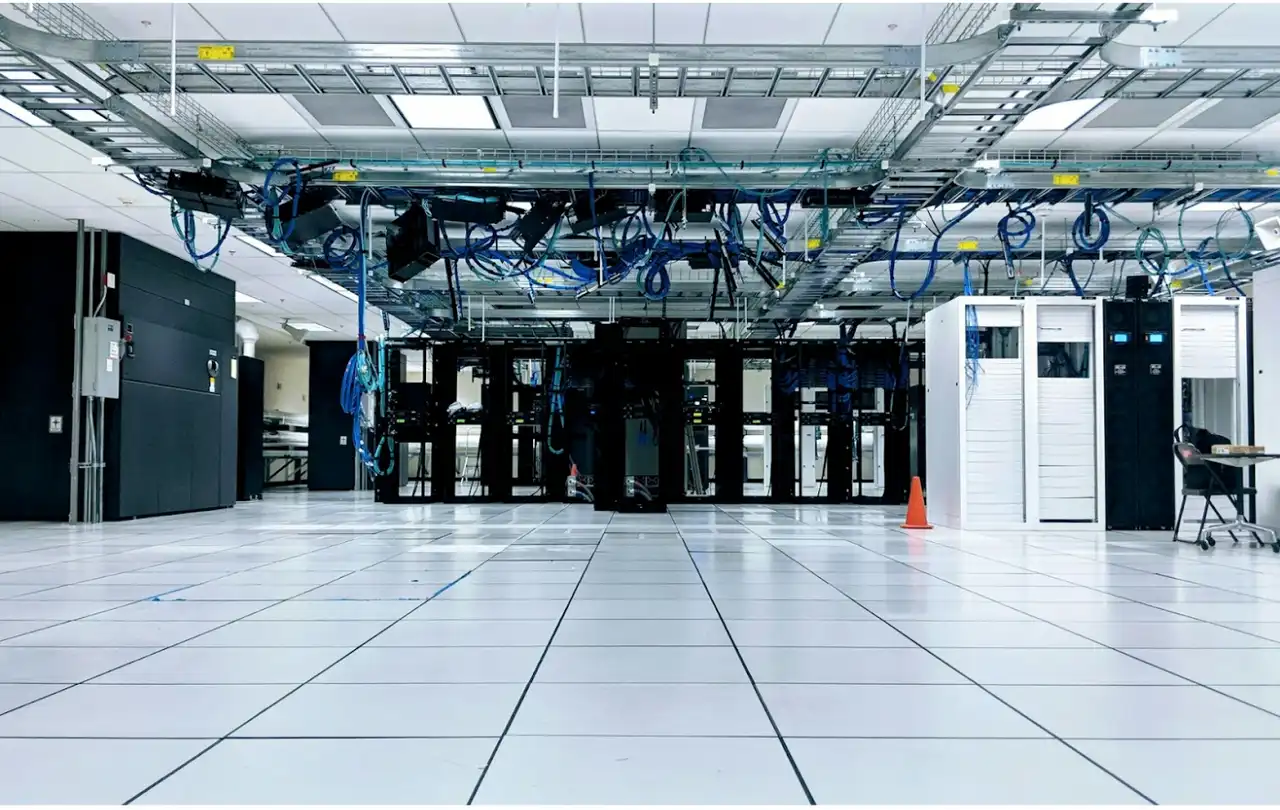 Data center with structured cabling and overhead fiber pathways illustrating enterprise network infrastructure using OM1 vs OM3 multimode fiber and pre-terminated fiber optic cable systems