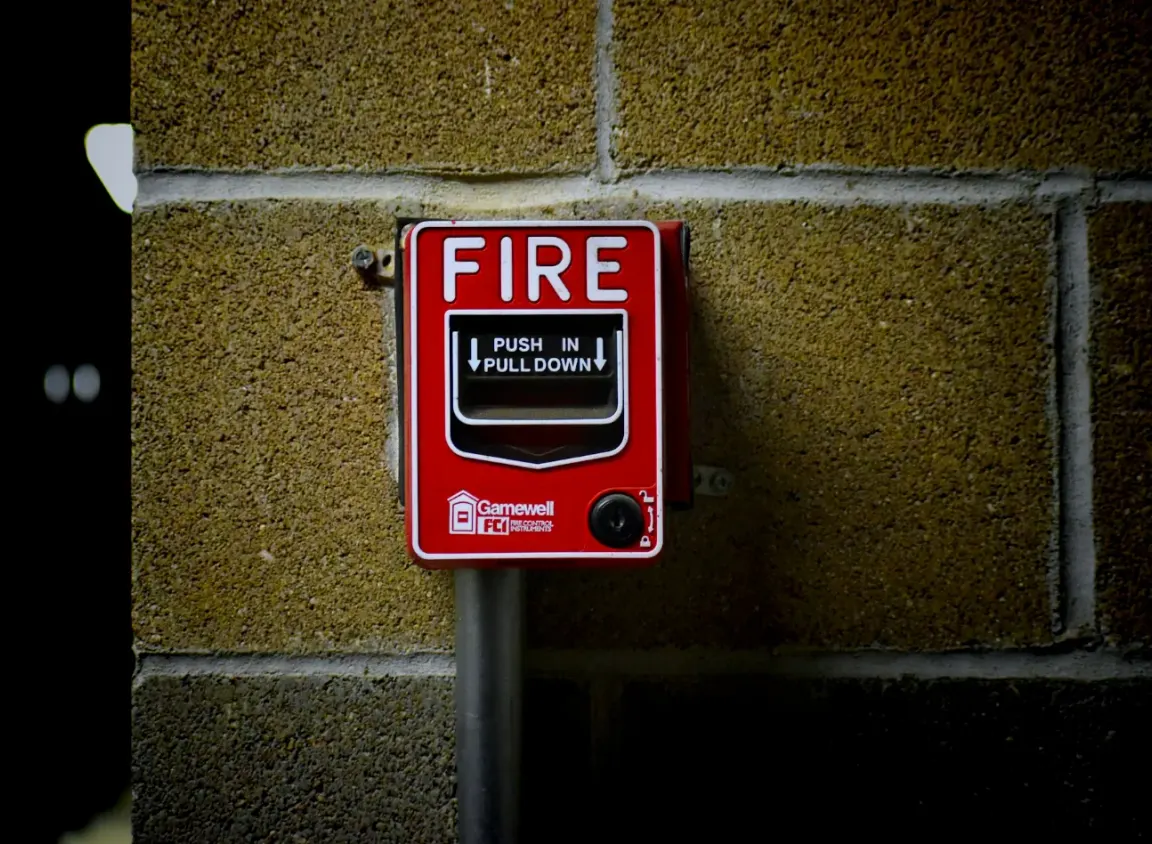 Commercial fire alarm pull station connected to life safety infrastructure supported by 12 AWG armored fire alarm cable in harsh environments.