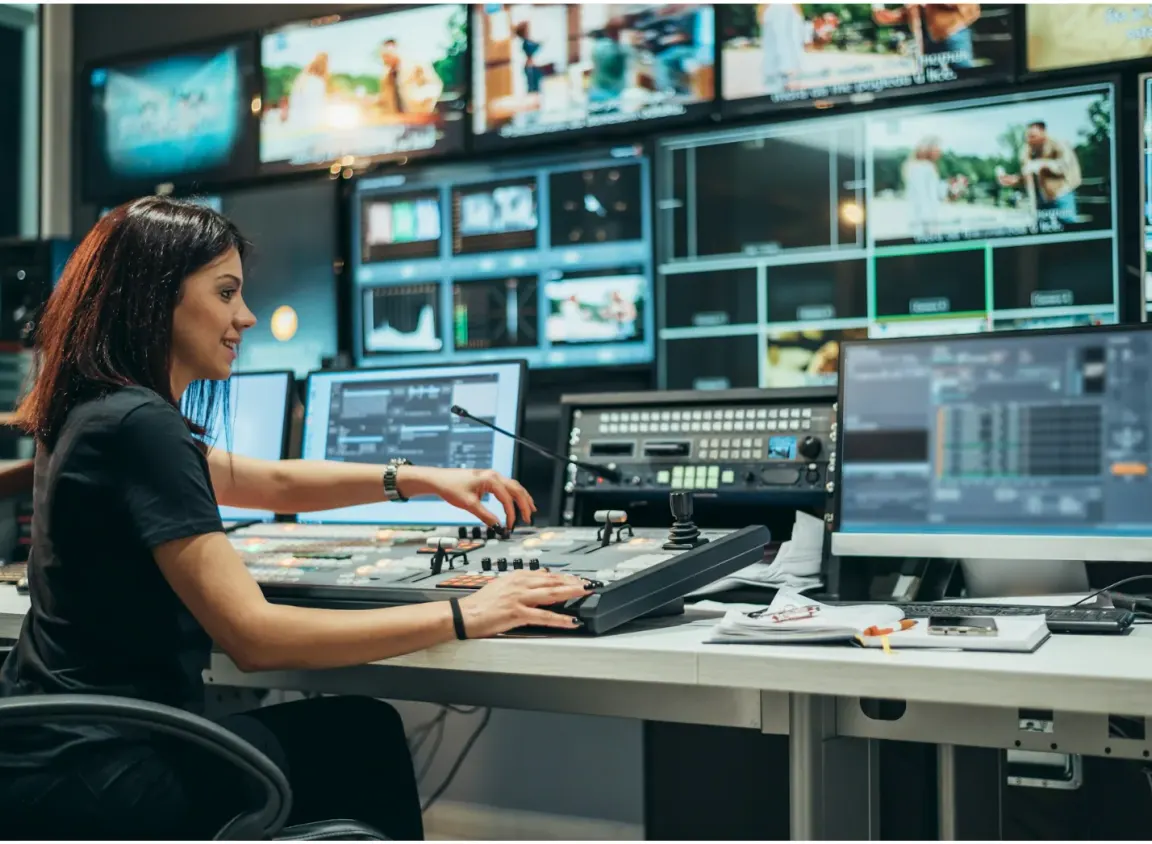 Broadcast control room operator managing video routing and signal distribution systems within a professional AV and media infrastructure environment