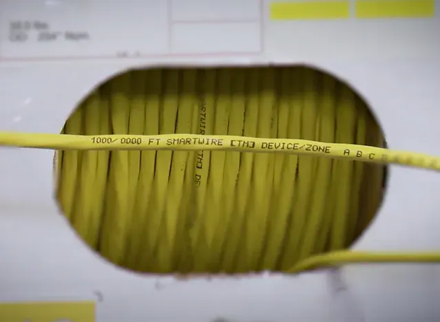 SmartWire cable exiting a dispenser box with sequential footage markings printed on the jacket for easy run planning.