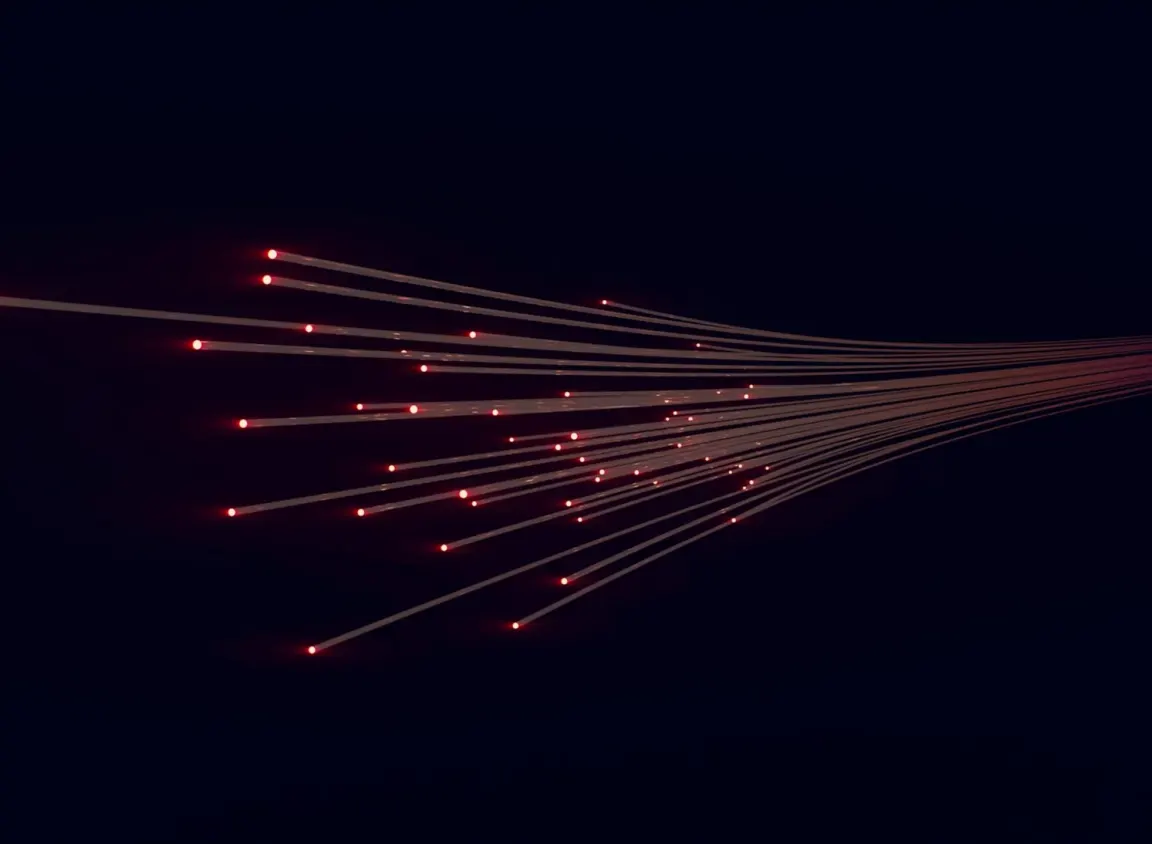 Premade fiber optic cable transmitting data through illuminated optical fibers in a high-performance network infrastructure environment.