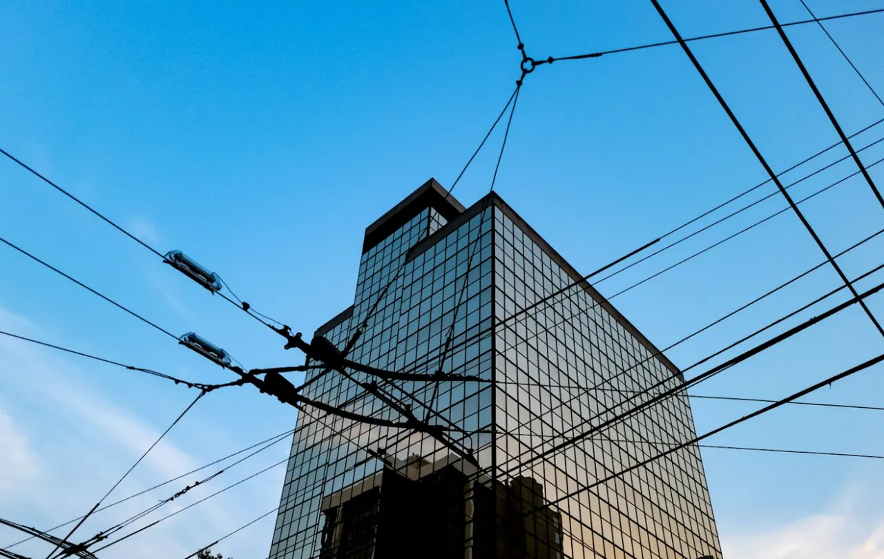 Outdoor wire and cable exposed to environmental conditions near a commercial building.