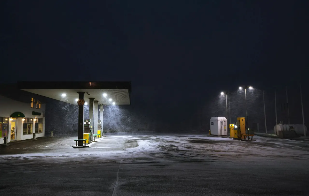 Snow blowing across a commercial fuel station at night, illustrating the harsh petroleum environment where oil-resistant wire must withstand moisture, temperature stress, vibration, and fuel exposure.